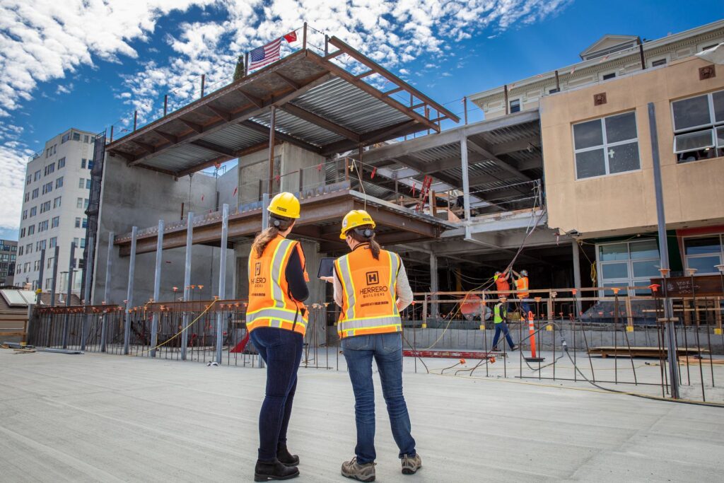 Two female contractors from Herrero Builders and HoloBuilder work on The Hamlin School in San Francisco